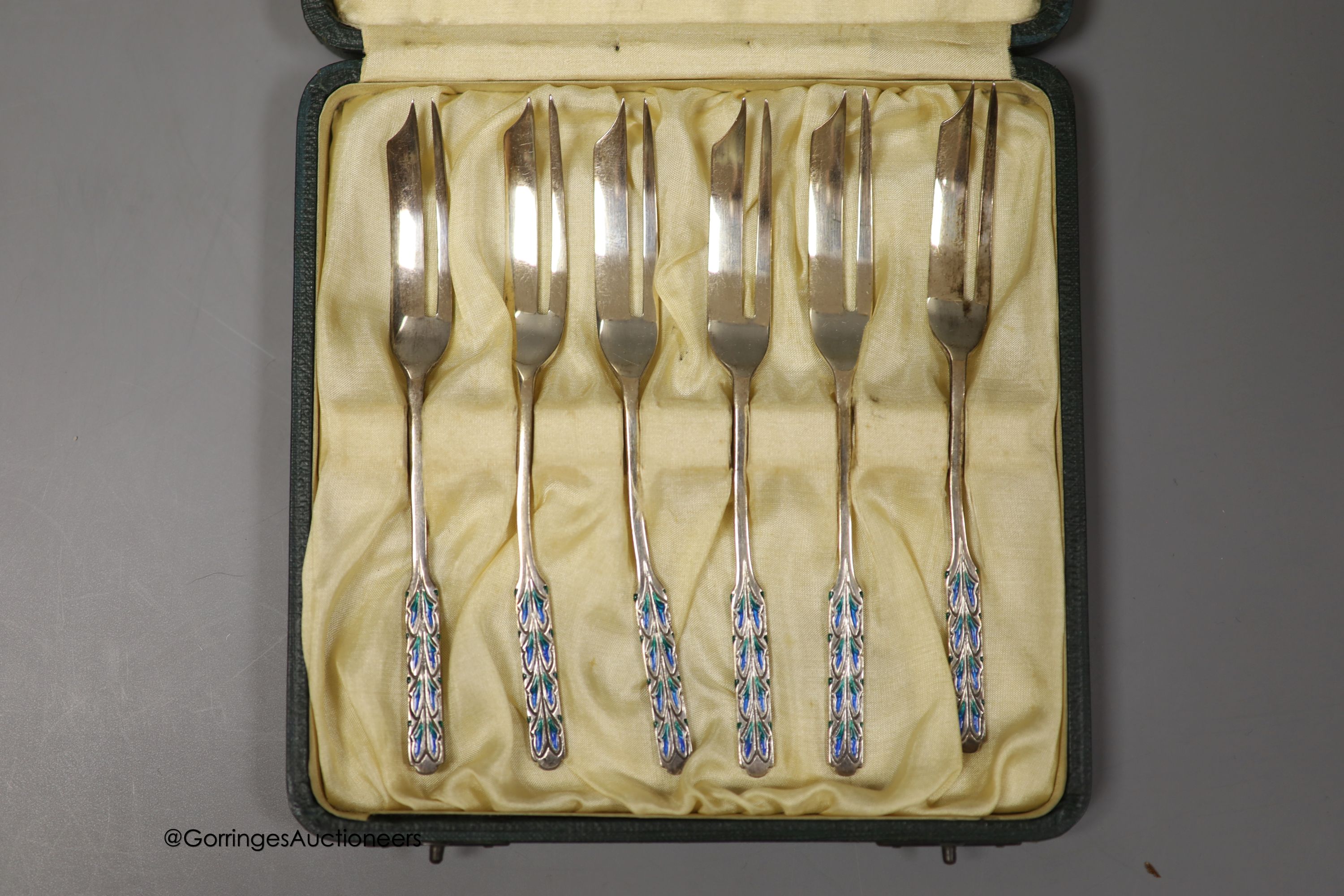A cased set of George V Liberty & Co silver and enamel pastry forks, Birmingham, 1928, in original Liberty & Co box